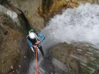 At the start of a 66 ft high rappel down, Pissarde, Vercors range